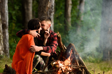 Couple in love at picnic with fire in forest, © be free