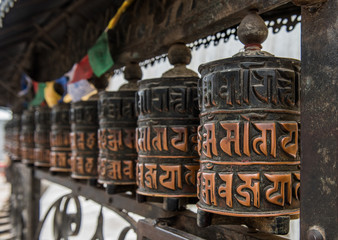 Buddhist prayer wheels at Swayambhunath ( monkey temple) Kathmandu, Nepal - Powered by Adobe