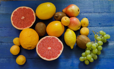 Fruit on blue wooden background.