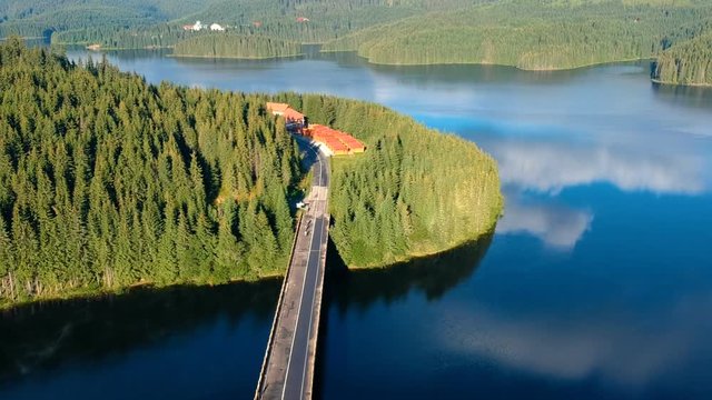 Aerial view of a road crossing Oasa lake, near Transalpina and Sibiu, Romania