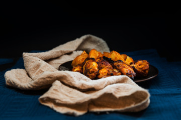 Chicken wings with sauce and golden French fries potatoes