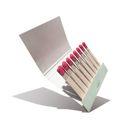 red head paper book of matches up on a corner