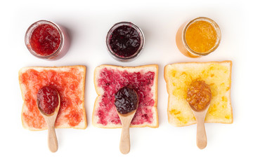 Toast sandwiches with strawberry, orange and blueberries jam isolated on white background, top view