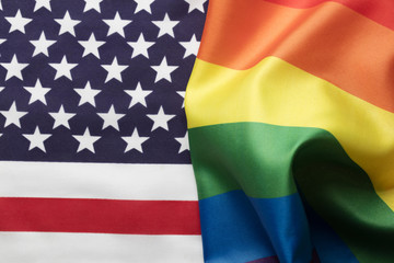 American stars and stripes flag alongside a gay Pride LGBT rainbow flag