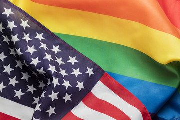 American stars and stripes flag alongside a gay Pride LGBT rainbow flag