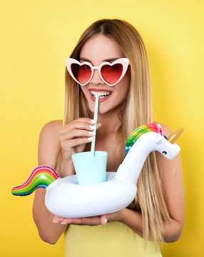 Young smiling woman drinking juice