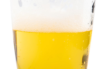 Pouring beer with bubble froth in glass for background.
