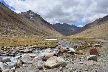 China, Tibet. Mountain river near the trail of parikrama around Kailas after the descent from the...