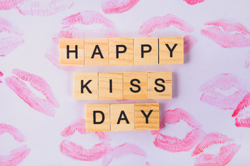 Concept for the International Day of Kisses. Lip prints on paper and text Happy day kisses.