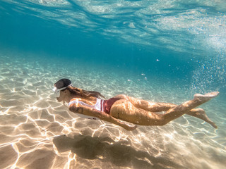Woman swimming underwater in sea
