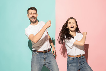 A couple of young man and woman dancing hip-hop at studio.