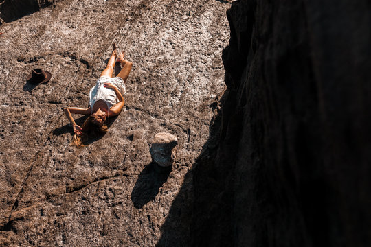 Relaxed woman lying on solid rock
