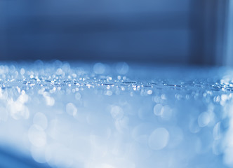 Blue glass with raindrops background texture horizontal top view isolated, rain on the window backdrop, abstract light bokeh and defocus drops, space blank back outdoors, mockup rainy