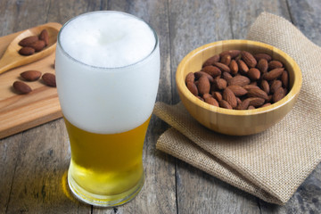 almond peanut and beer on table