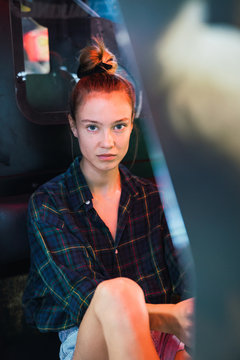 Woman sitting in arcade machine