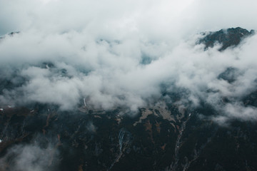 Obraz premium Beautiful dark moody scary mountain landscape in the fog