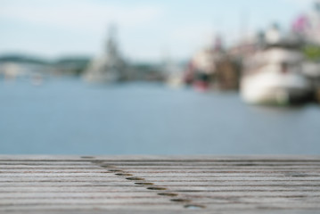 Empty wooden table, with blurry nice ocean background