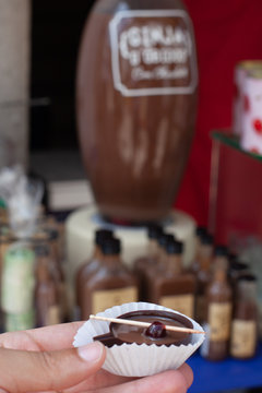 Ginjinha de &Oacute;bidos - Portugal. A typical sweet liqueur served in chocolate cups, with a cherry. Made by infusing ginja berries, (sour cherry), in alcohol (aguardente) and sugar.