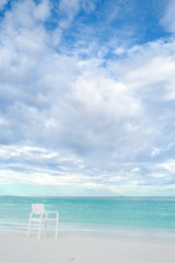 Summer concept , White chair on the beach white sand and turquoise sea color at maldives on the weekend holidays