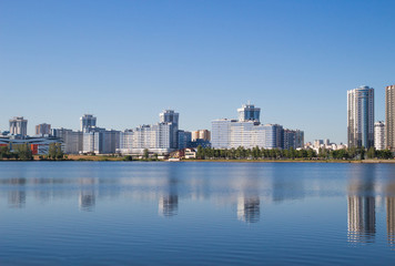 Fototapeta na wymiar The city of Minsk, a bright day. Houses, water, sky. Landscape