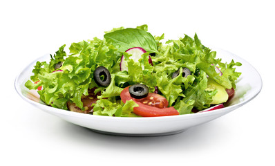 Delicious fresh salad dish on a white plate, isolated on white background. Healthy eating scene, fresh lettuce, tomatoes, cucumber and olives in a bowl.