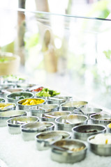 bowls of mixed fresh organic vegetables in salad bar display