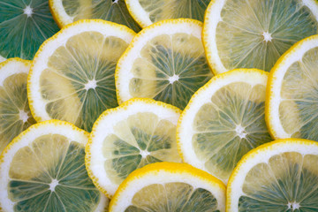 Fresh lemons background. Yellow food background. Juicy slices of lemon. Top view