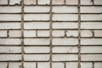 Old realistic brick wall made of white brick. White uneven brickwork..