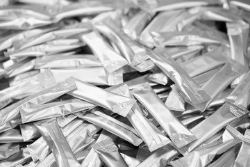 background heap of many clean packing aluminium for powders or soluble beverages or medicines