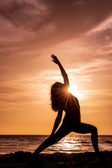 Woman Practicing Yoga on a Maui Beach at Sunset