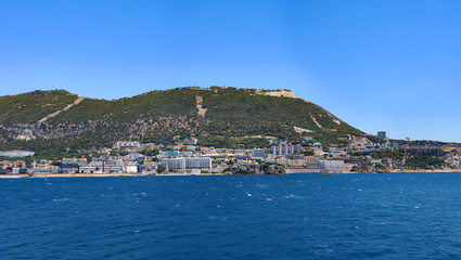 Naklejka na ściany i meble Day view to Gibraltar rock from sea, architecture of Gibraltar