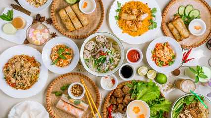Assorted asian dinner, vietnamese food. Pho ga, pho bo, noodles, spring rolls - 212127480