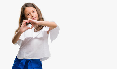 Brunette hispanic girl smiling in love showing heart symbol and shape with hands. Romantic concept.