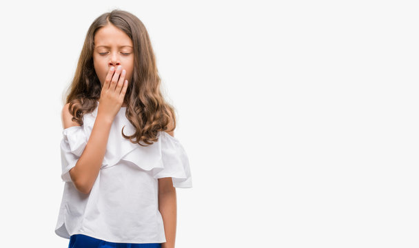 Brunette hispanic girl bored yawning tired covering mouth with hand. Restless and sleepiness.