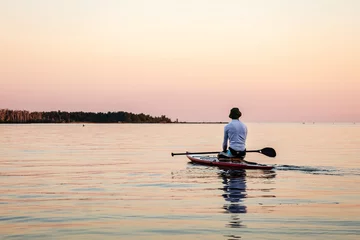 Foto op Canvas Paddle board rider at sunrise on calm water © LorneChapmanPhoto