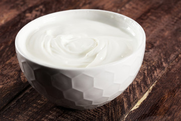 close up of a white whipped or sour cream in bowl.