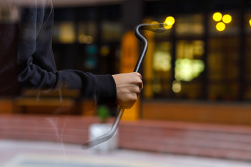 Burglar with a crowbar on the background of the shop.