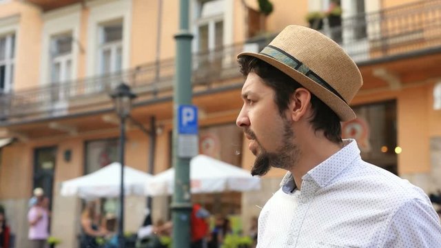 portrait of confident italian stylish man walking in the city and smoking cigarette cool bearded guy successful city lifestyle summer day light men casual fashion look businessman freelancer