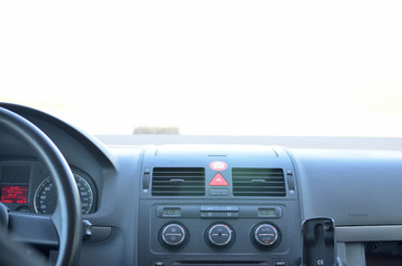 Obraz na płótnie Canvas Car interior with windshield blinded by sun