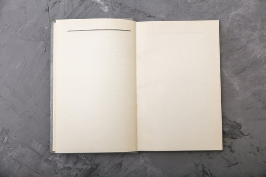 open old book on a gray background. view from above