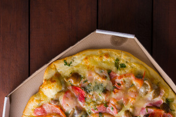 Italian pizza on wooden boards, pizza with bacon, dried tomatoes and Parmesan cheese, Italian cuisine, appetizing dish with meat and cheese, art