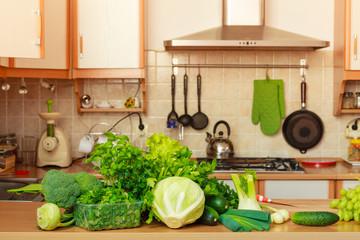 Many green vegetables on kitchen table