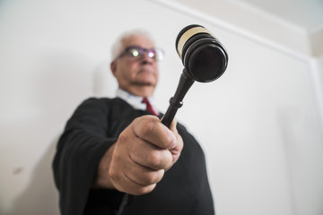 Naklejka premium judge with a hammer in his hand in the court room 