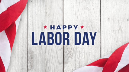 Fototapeta na wymiar Happy Labor Day Text Over White Wood Wall Texture Background and American Flags