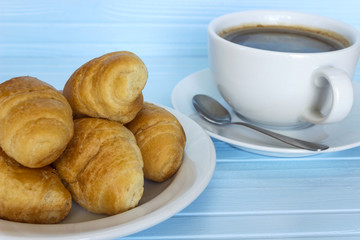 Coffee and croissants in a plate 