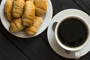 Coffee and croissants in a plate , from above