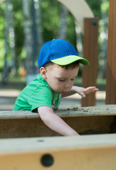 The boy plays in the playground