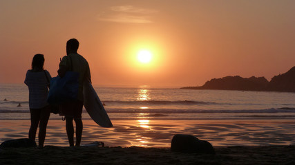 couple surfer silhouette at sunset