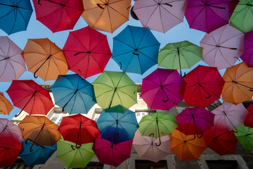 Fototapeta na wymiar Multi-Coloured Street Umbrellas hanging in Carcassonne. South France. Summertime. 