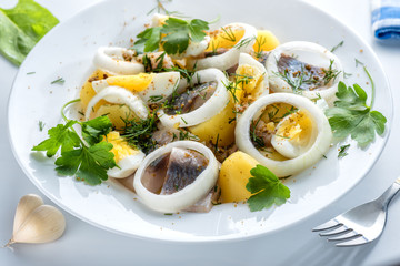 Potatoes with herring, eggs and spices